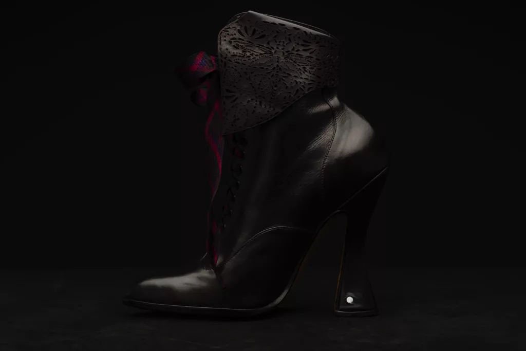 Side view of the high heeled Oxford bootie. Dark black leather with dragonfly laser cut outs and purple contrasting lacing