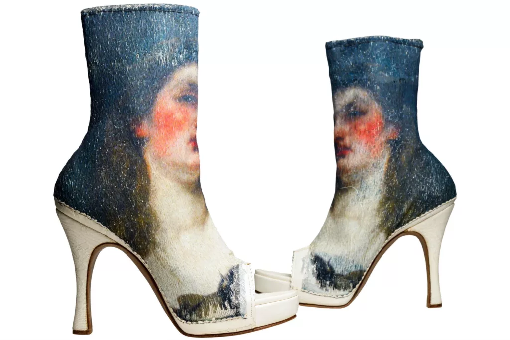 Statement worthy, open toe booties on a white leather platform. Uppers filled with a highly detailed silk embroidery of the clients choice. Oak bark tanned leather sole and top piece. Embroidery includes a portrait of a woman.