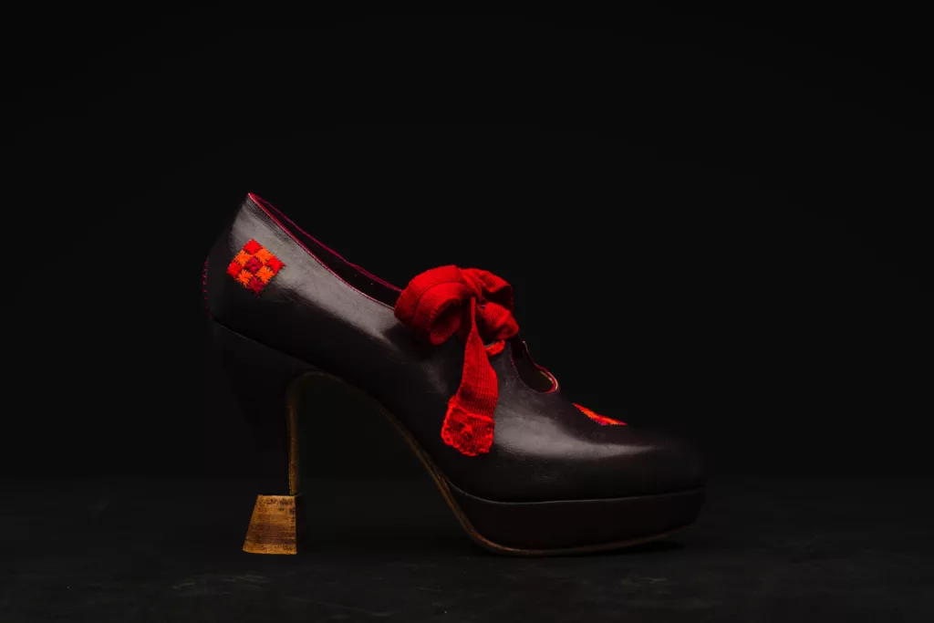 The Folk high vamp court shoe is folk inspired. with a Louis heel featuring multiple leather stacks. The laces are a Vintage silk French ribbon in a striking red. Hand stitched details of this same hue are featured throughout the upper, which is a Veg tanned leather.