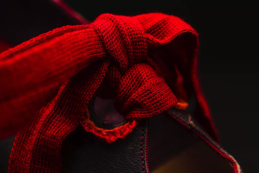 Beautiful striking red woven oversided lace detail and hand embroidered eyelets